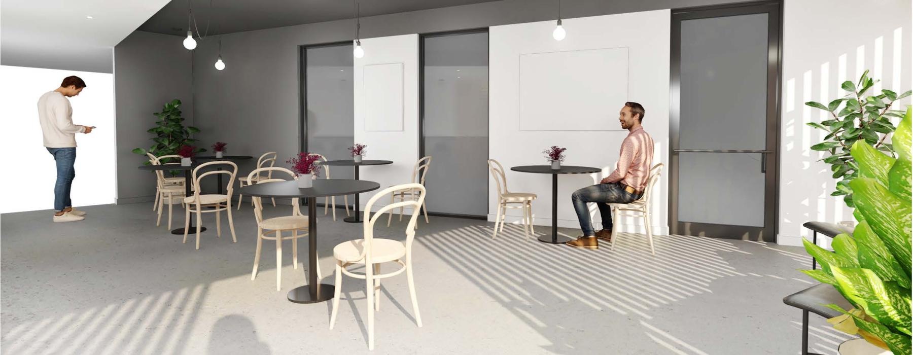 a man and a woman in a room with white walls and tables